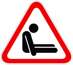 Red triangle which contains slumped person.