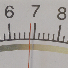 Parallax error on an analog meter. The needle's reflection, visible on the mirror below the scale, indicates that this is an improper viewing angle. Source: University of Cincinnati-Clemont. 
