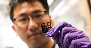 Postdoctoral researcher Yuanyuan Wang holds a ‘mask’ used in a new process that makes it easier to build nanomaterials into transistors, solar cells and other devices. Image credit: Jean Lachat