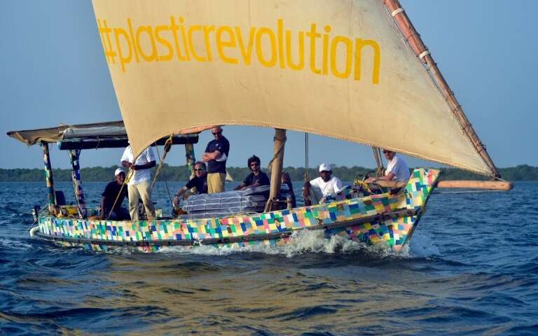 The boat is covered in a brightly-colored patchwork of 30,000 flip-flops, which like the rest of the raw material was collected from Kenyan beaches and towns. Source: AFP