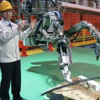 The crane-like device will use two robotic arms to retrieve and dismantle debris from the spent fuel pool.