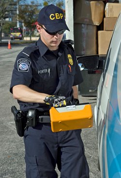 A U.S. Customs and Border Protection Officer checks a vehicle with a hand-held radiation detection unit. Image source: U.S. CBP