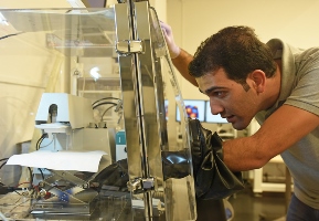 OIST student Zafer Hawash sets up a hanging mercury drop electrode system for conductivity measurement. Image credit: OIST.
