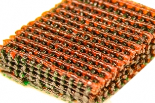 Image shows the open lattice of 3D printed material, with materials having different characteristics of strength and flexibility indicated by different colors. Image source: MIT