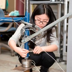 Architectural engineering student Xiao Yuan connects and secures CPS sensors on a temporary-structure simulation. Image credit: Penn State.