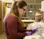 Graduate student Heather Siebert tests the adhesive. 
