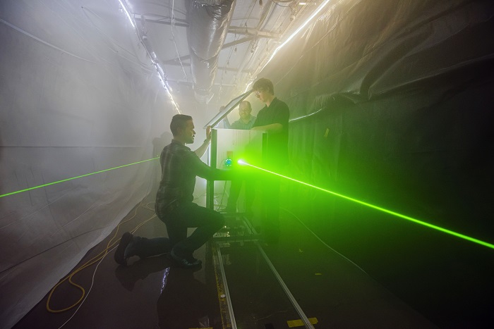 Researchers prepare for an optical test in the SNL fog facility. Source: Randy Montoya 