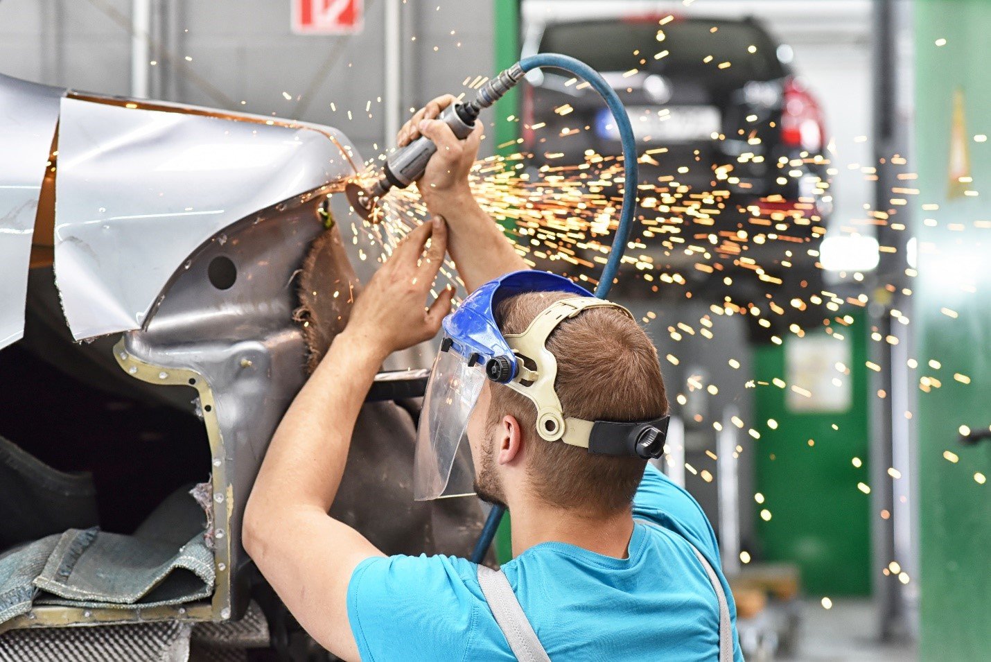 Figure 1. Technician grinding automotive body panels. Source: industrieblick/Adobe Stock