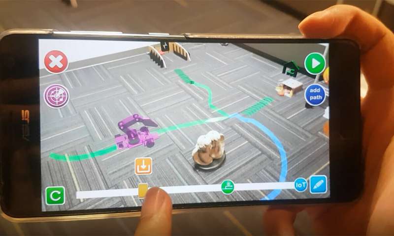 A smartphone app allows a user to plan a task for a robot to perform. The robot carries out the task automatically once the phone is loaded onto its docking station. Source: Purdue University image/C Design Lab