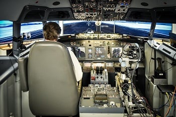An IT specialist at the John A. Volpe National Transportation Systems Center flies a Boeing 737-800NG simulator with Aurora’s ALIAS technology demonstration system as his co-pilot.