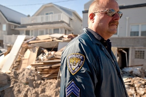 Long Beach Police Sgt. Eric Creegen views damage caused by Hurricane Sandy. Image credit: Andrea Booher/FEMA.