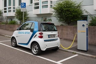 An electric vehicle charging at an on-street station. Source: wikipedia.com