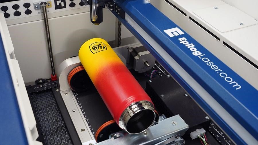 Figure 2: Epilog’s ‘rim-style’ rotary attachment is an optional accessory that adds the ability to engrave cylindrical items to the Fusion Edge line. Source: Epilog Laser