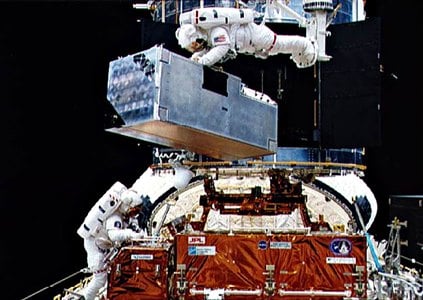 Shuttle Endeavor astronauts move replacement parts into the HST. Image source: European Space Agency.