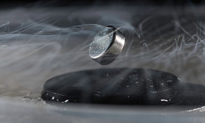 Until now, extreme cold has been required to achieve superconductivity, as demonstrated in this photo, in which a magnet floats above a superconductor cooled with liquid nitrogen. Source: University of Rochester/J. Adam Fenster