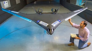Boeing engineer Stephen Provost checks out a blended wing body model before a wind tunnel test run at NASA Langley. Image credit: NASA/David C. Bowman.