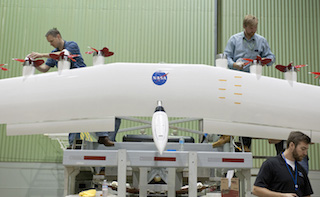 Sean Clarke (l), Kurt Papathakis and Anthony Cash (foreground) work on an experimental wing. Image credit: NASA.