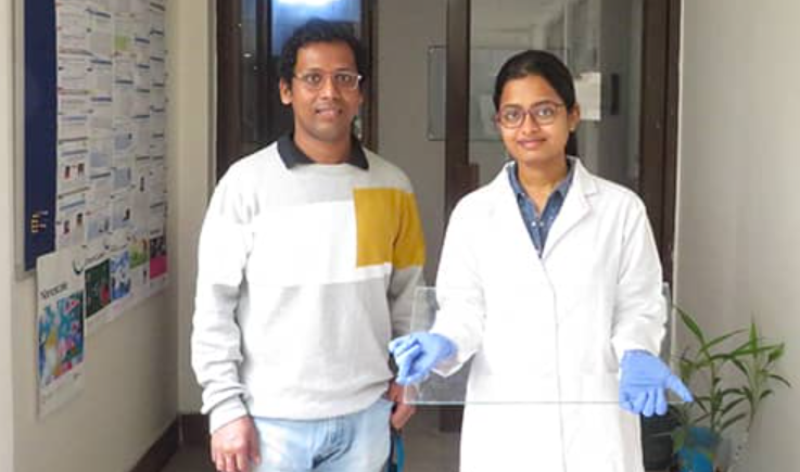 Researchers with the self-healing amphiphobic solid slippery coating applied glass. Source: IIT Guwahati