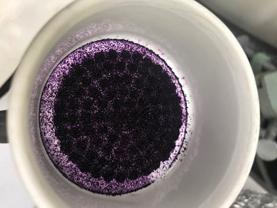 The self-assembling molecular traps, with purple microcrystals, interact with certain PFAS. Source: Heshali Welgama