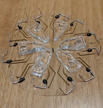 Six devices, each on a 3 in wide piece of glass, with biosensors designed to detect whether a cancer cell is alive when it passes through a microfluidic channel. Source: Zhongtian Lin, Rutgers University 