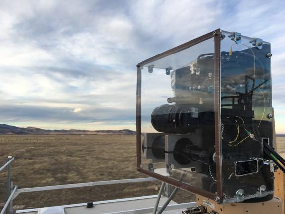 This optical head holds the laser launching system that launches laser light out to retroreflectors located 1 kilometer away. It is shown operating during a test conducted at the Table Mountain Test Facility in Colorado. (Source: Sean Coburn, University of Colorado in Boulder)