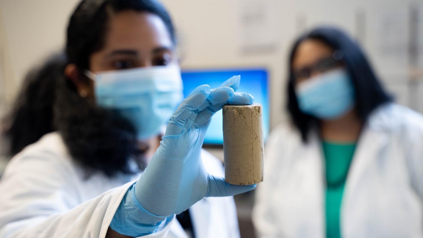 UBCO Postdoctoral Research Fellow Dr. Chinchu Cherian, along with Associate Professor Dr. Sumi Siddiqua, examines a road-building material created partly with recycled wood ash. Source: UBCO