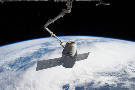 The International Space Station's Canadarm2 robotic arm captures the Dragon spacecraft for docking to the station in March 2013. Credit: NASA