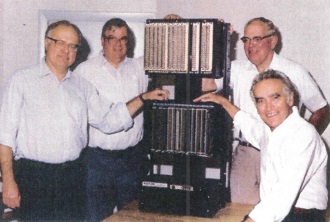 The Modicon development team and the 084, left to right: Dick Morley, Tom Boissevain, the Modicon 084, George Schwenk, and Jonas Landau. Image source: Automation.com 