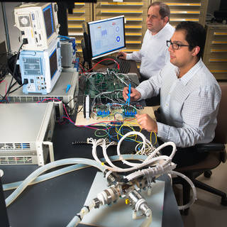 NASA Glenn engineers David Avanesian and Peter Kascak test a flywheel motor designed for a pediatric heart pump. Image source: NASA/Bridget Caswell.