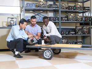 Associate Professor of Electrical Engineering Bill Diong (l) works with graduate student researchers to develop autonomous in-wheel motors. Image credit: Lauren Lopez de Azua.