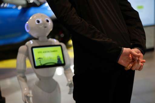 A guest asks robot Robby Pepper for information a hotel in Peschiera del Garda, northern Italy. Robby Pepper, billed as Italy's first robot concierge, has been programmed to answer simple guest questions in Italian, English and German. The humanoid, speaking robot will be deployed all season to help relieve the desk staff of simple, repetitive questions. Source: AP Photo/Luca Bruno