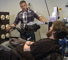 Pitt Assistant Professor Robert Gaunt prepares Nathan Copeland for BCI sensory tests.