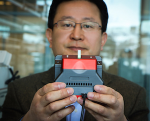 UU Professor Ling Zang holds up the prototype hand-held detector. Image credit: UU College of Engineering/Dan Hixson.