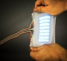 Cornell grad students developed a highly stretchable electroluminescent skin. Photo credit: Chris Larson 