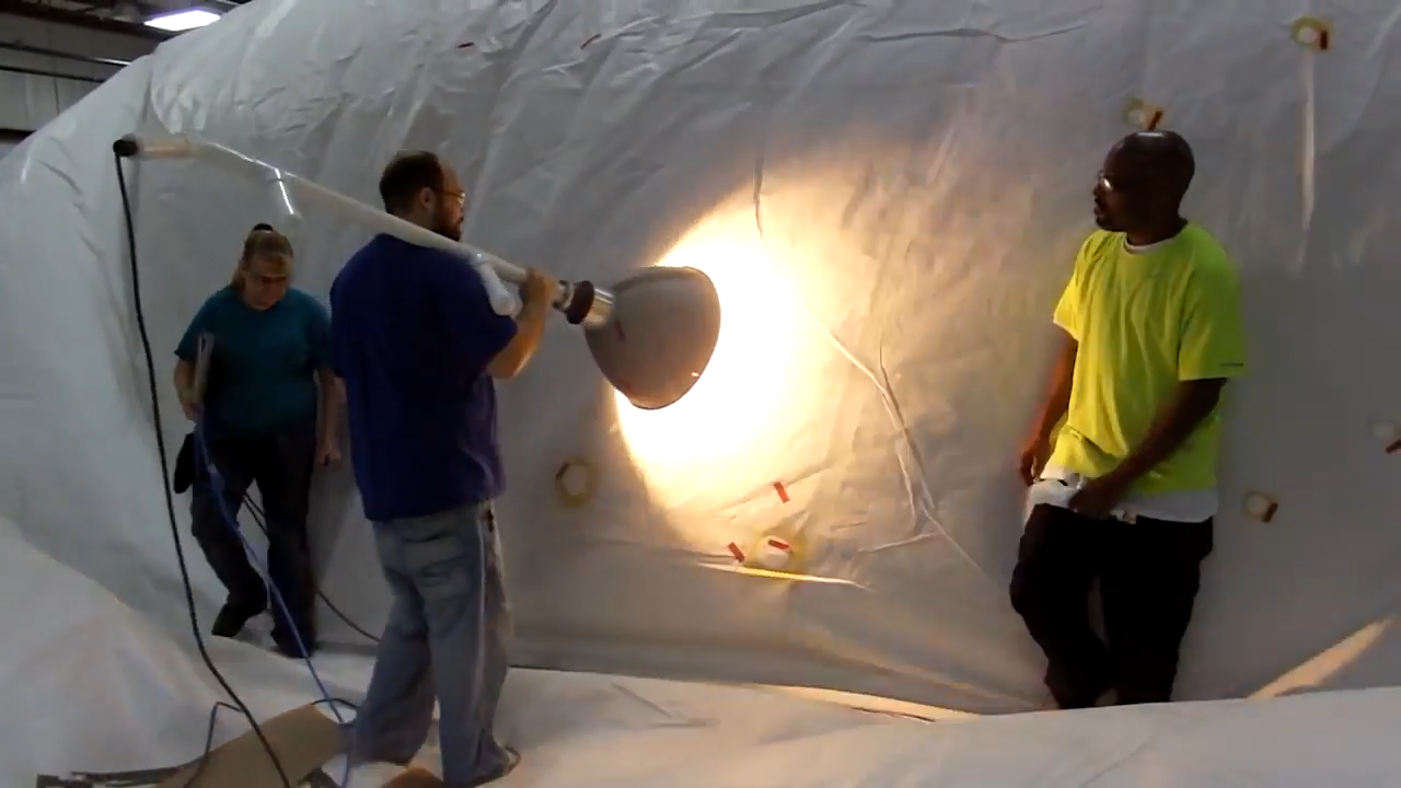 Lockheed Martin repair crew looking for pinholes in the skin of a hybrid airship. Source: Lockheed Martin