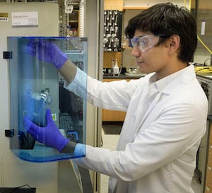 Purdue doctoral student Arthur Dysart operates a system that measures the adsorption of gas molecules on a solid carbon surface. Image credit: Purdue University/John Underwood.