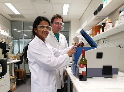 Ph.D. student Ruchira Ranaweera loads a wine sample into the Aqualog spectrofluorometer, with associate professor David Jeffery. Source: University of Adelaide.