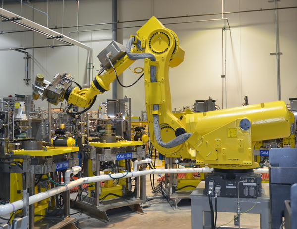 Igor, a training robot, lifts a 155 millimeter shell to demonstrate how liquid mustard agent is removed. Source: PCAPP