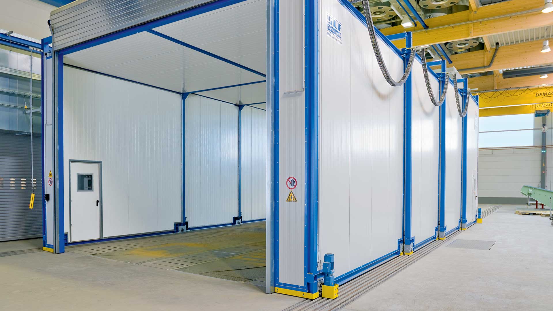 Figure 7: This paint booth is expandable to fit different sized components. The output torque of the gearbox is what moves the panels at the appropriate speed. Source: Demag