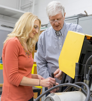 Brittany Newell, assistant professor of engineering technology, and Gary Krutz, professor of agricultural and biological engineering, examine hydraulic hoses used in mechanical machinery. Image credit: Purdue Research Foundation.