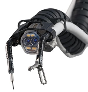 The distal end of the Flex Drive includes the camera, LEDs, and accessory channels through which the surgeon inserts custom-designed instruments.