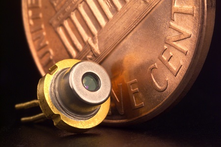 Figure 1. A diode laser with a 0.75 in diameter penny for scale. The device’s small form factor and high power characteristics make it ideal for unique welding applications.