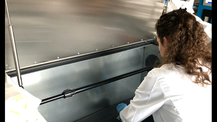 A researcher from the Georgia Tech and Emory University places items into an ozone disinfection chamber for testing. Source: Georgia Tech