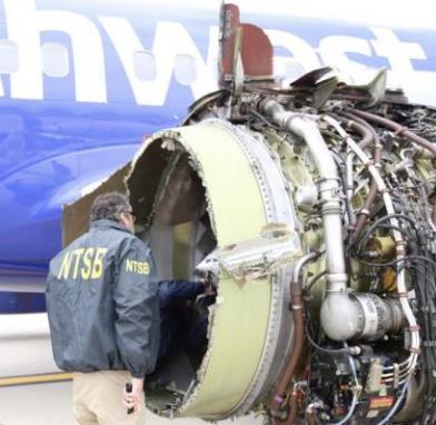 An NTSB inspector examines the failed engine on April 17. Credit: UPI