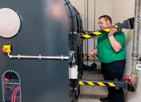 FAU researcher David Hochrein stands next to a 16-ton spin test stand that exposes bearings to extreme centrifugal forces. 
