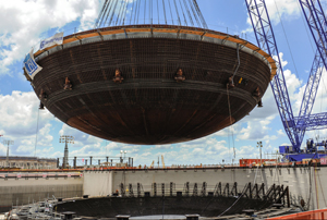 In this view from June  2013,  Vogtle construction crews place a 900-ton piece of the containment vessel into the Unit 3 nuclear island. Image source: Georgia Power.