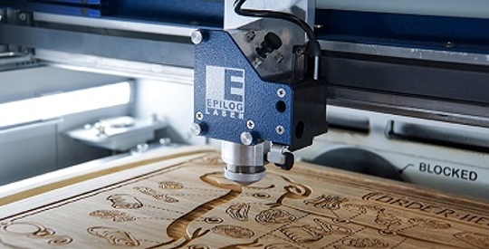 Figure 1: Cutting board inside an Epilog Laser machine. Source: Epilog Laser