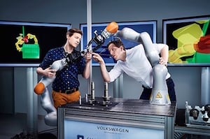 Dr. Wolfgang Hackenberg, head of the Volkswagen Smart Production Lab (l), and employee Johannes Teiwes are developing smart robots. Image credit: Volkswagen.