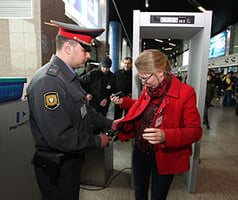 Law enforcement officer screens a passenger at the Vladivostok international airport in Russia. Image source:  Wikipedia