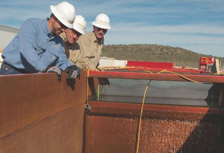 Workers watch Apache&rsquo;s water recycling process in the Barnhart area of West Texas. Credit: Apache